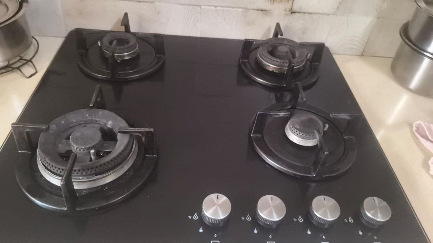 Damaged gas hob burner being examined by a technician